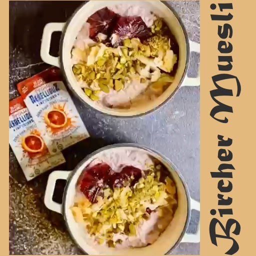 Overhead view of two large bowls of Bircher Muesli made with Rebellious Infusions—Blood Orange